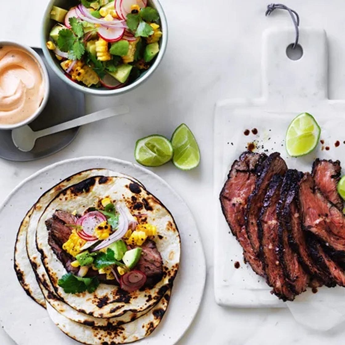 Flank steak tacos with corn, avocado and coriander