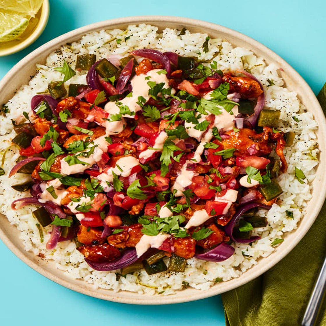 Saucy Chicken Burrito Bowls with Chicken Thighs, Charred Poblano, Smoky Crema & Cilantro Lime Rice