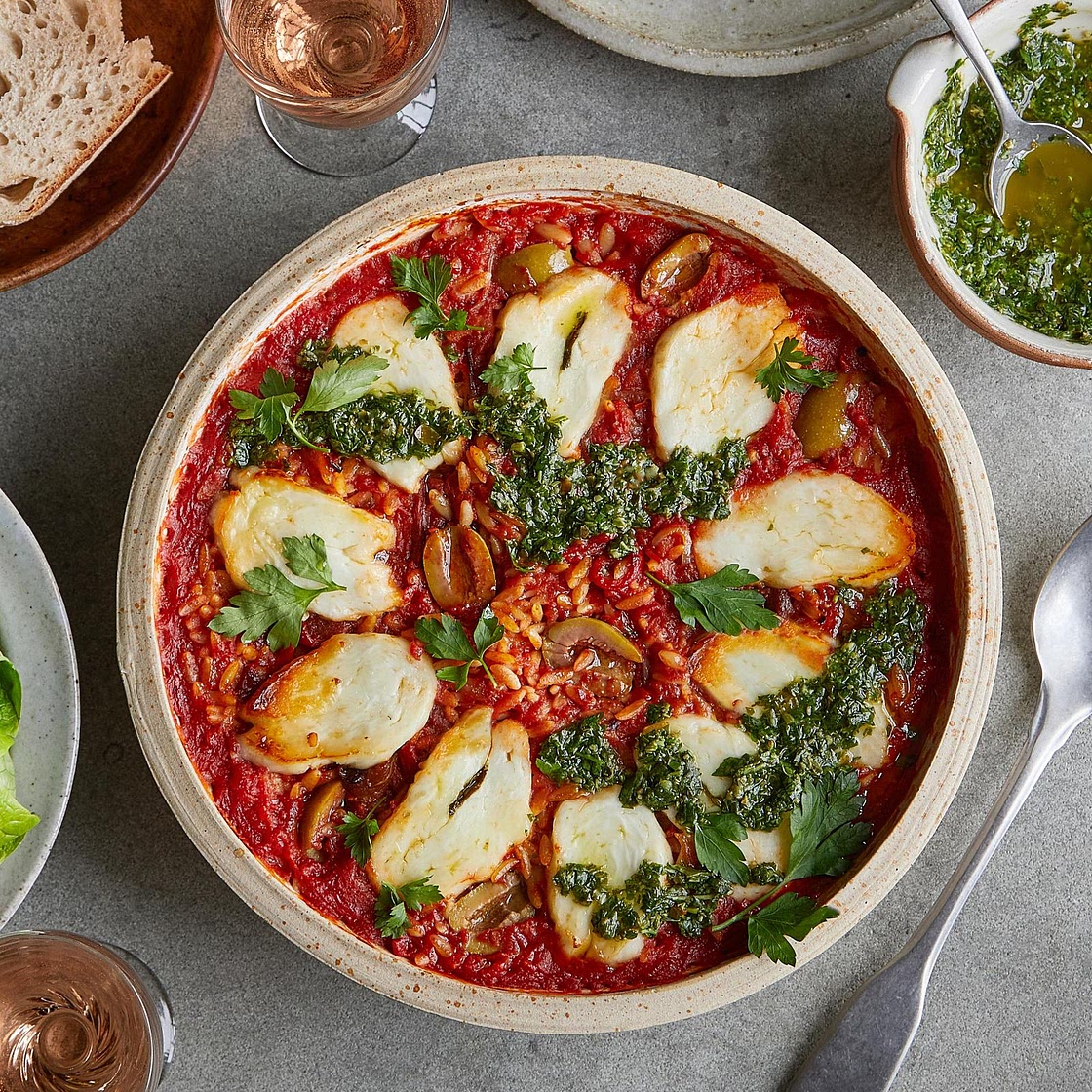 Baked orzo with sweet red peppers, olives and halloumi