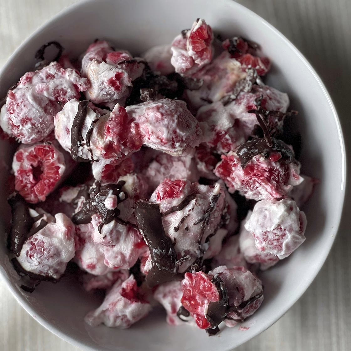 Easy Chocolate Covered Frozen Raspberries made with Yogurt