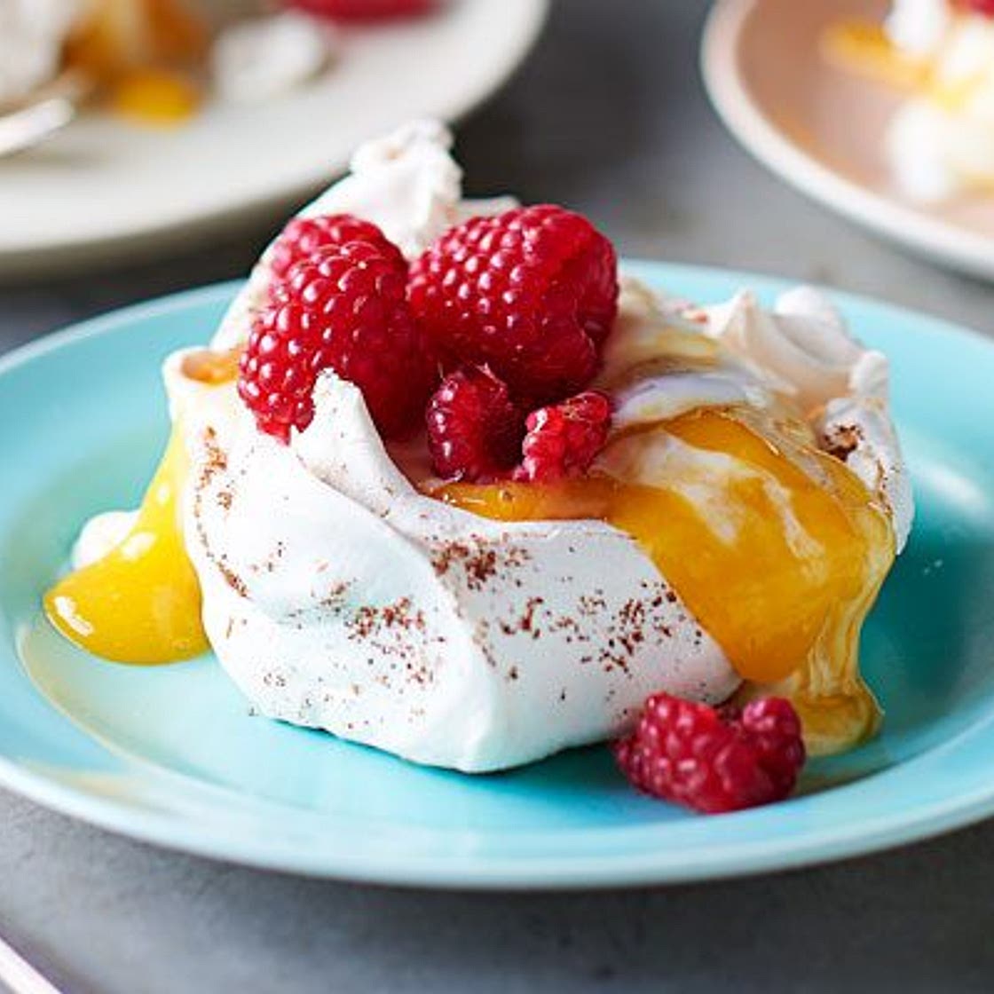 Star anise meringues with mango coulis & raspberries