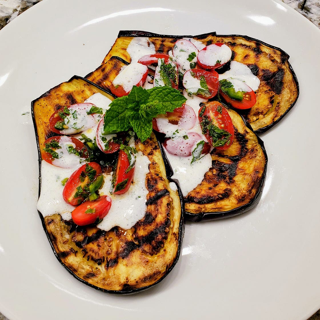 Grilled eggplant with tomatoes and yogurt sauce