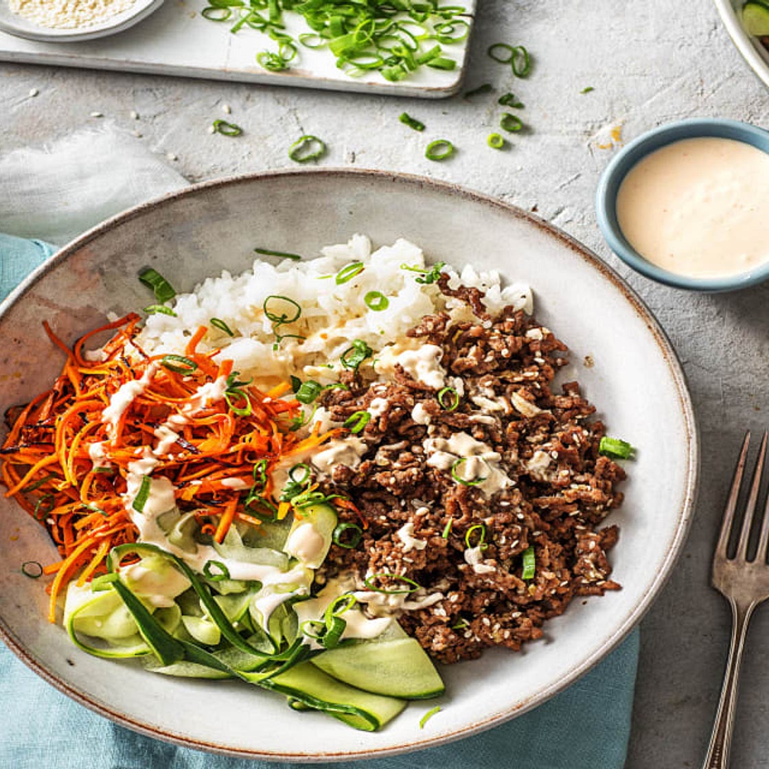 Ground Beef Bulgogi Bowls with Carrots, Cucumber, and Sriracha Crema over Jasmine Rice