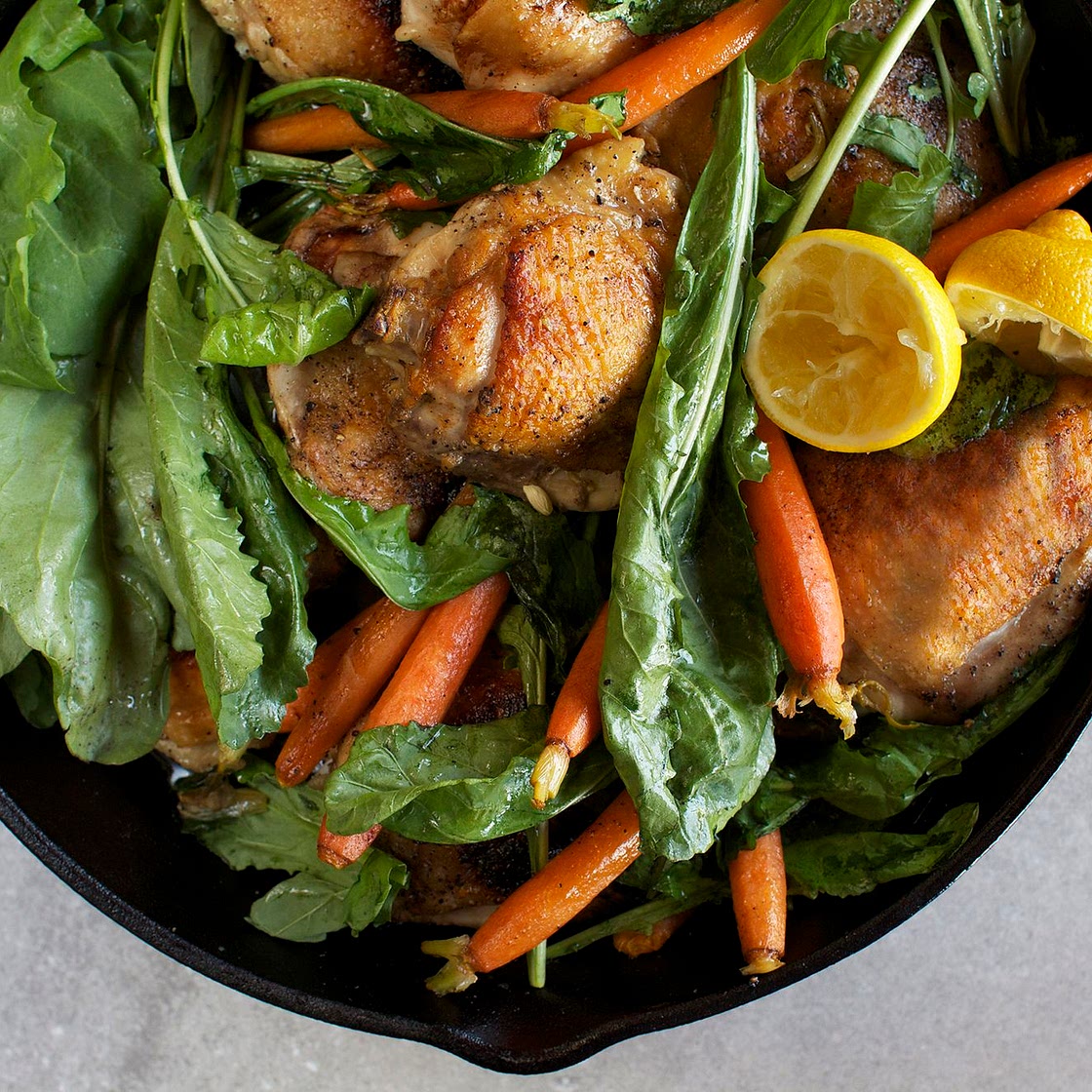 Skillet-Roasted Chicken Thighs With Dandelion Greens & Baby Carrots
