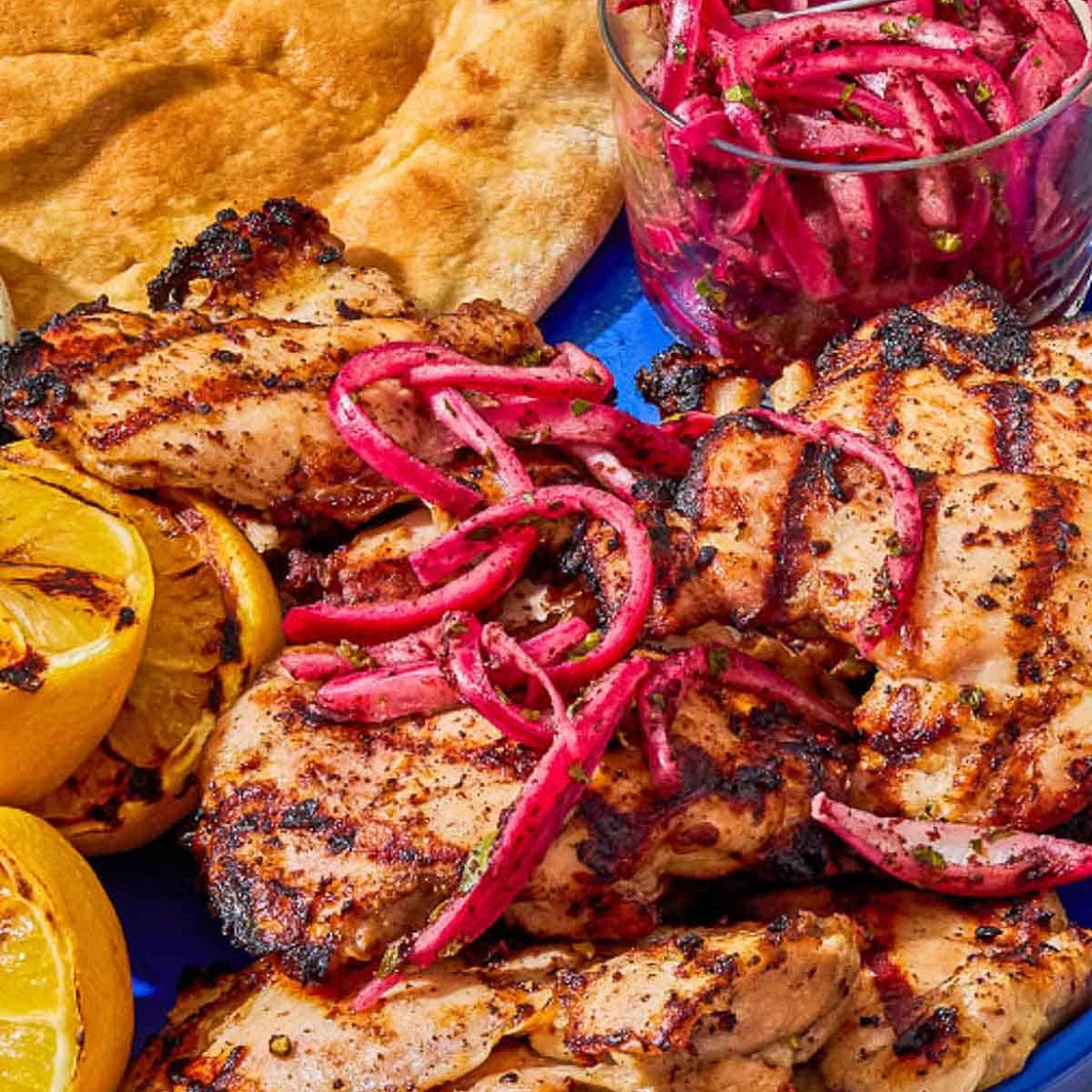 Grilled Chicken Thighs with Sumac, Pickled Onions, and Charred Lemon