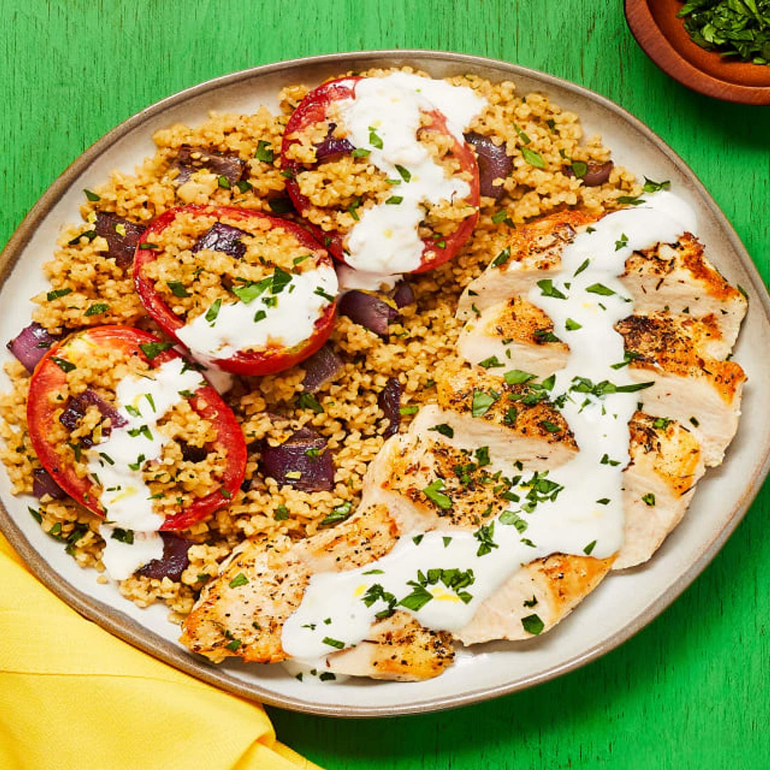 Za’atar-Spiced Chicken with Bulgur-Stuffed Roasted Tomatoes & Lemon Garlic Yogurt Sauce