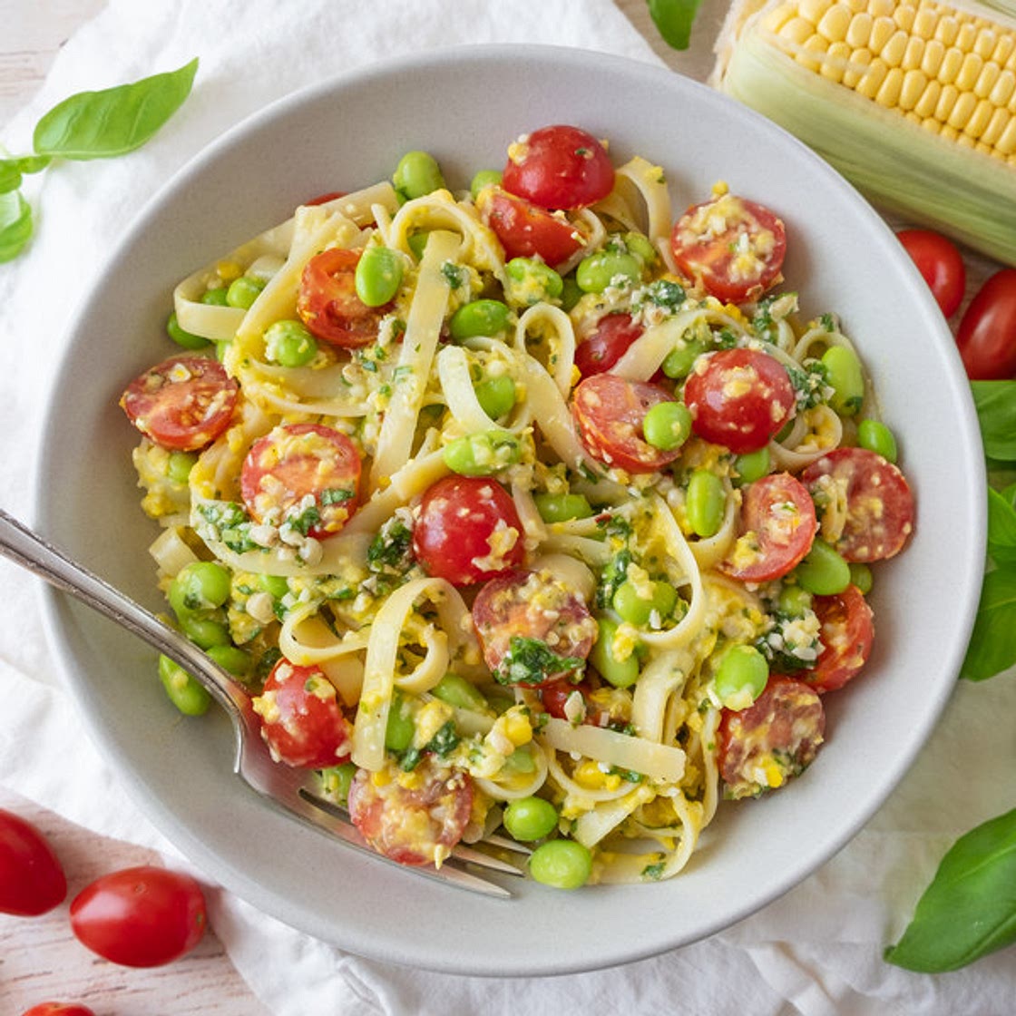 Creamy Corn Fettuccini with Edamame, Tomatoes & Basil Pesto