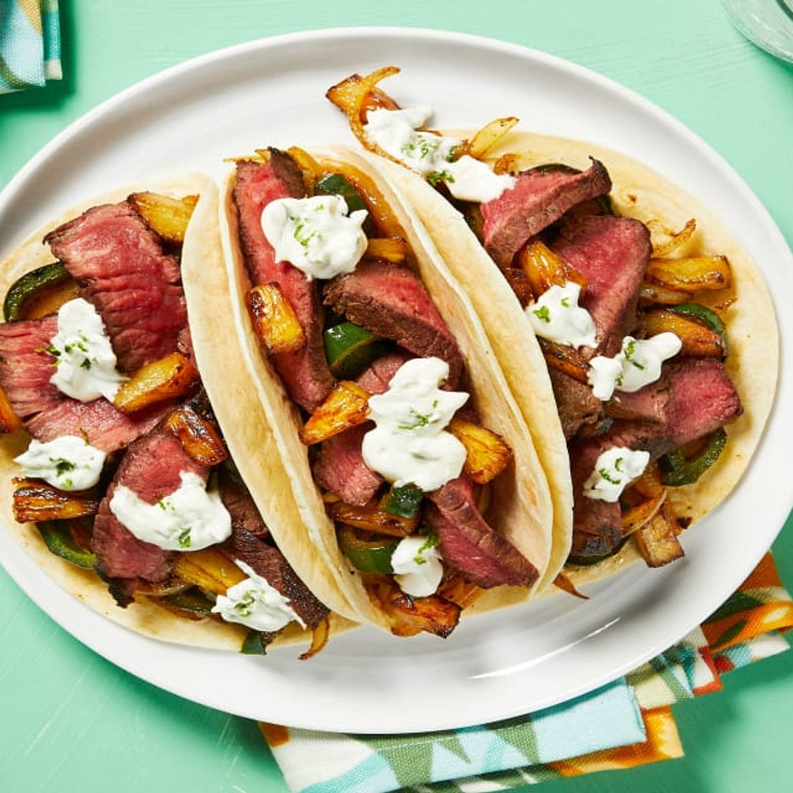 Marinated Steak Tacos with Charred Pineapple and Lime Crema