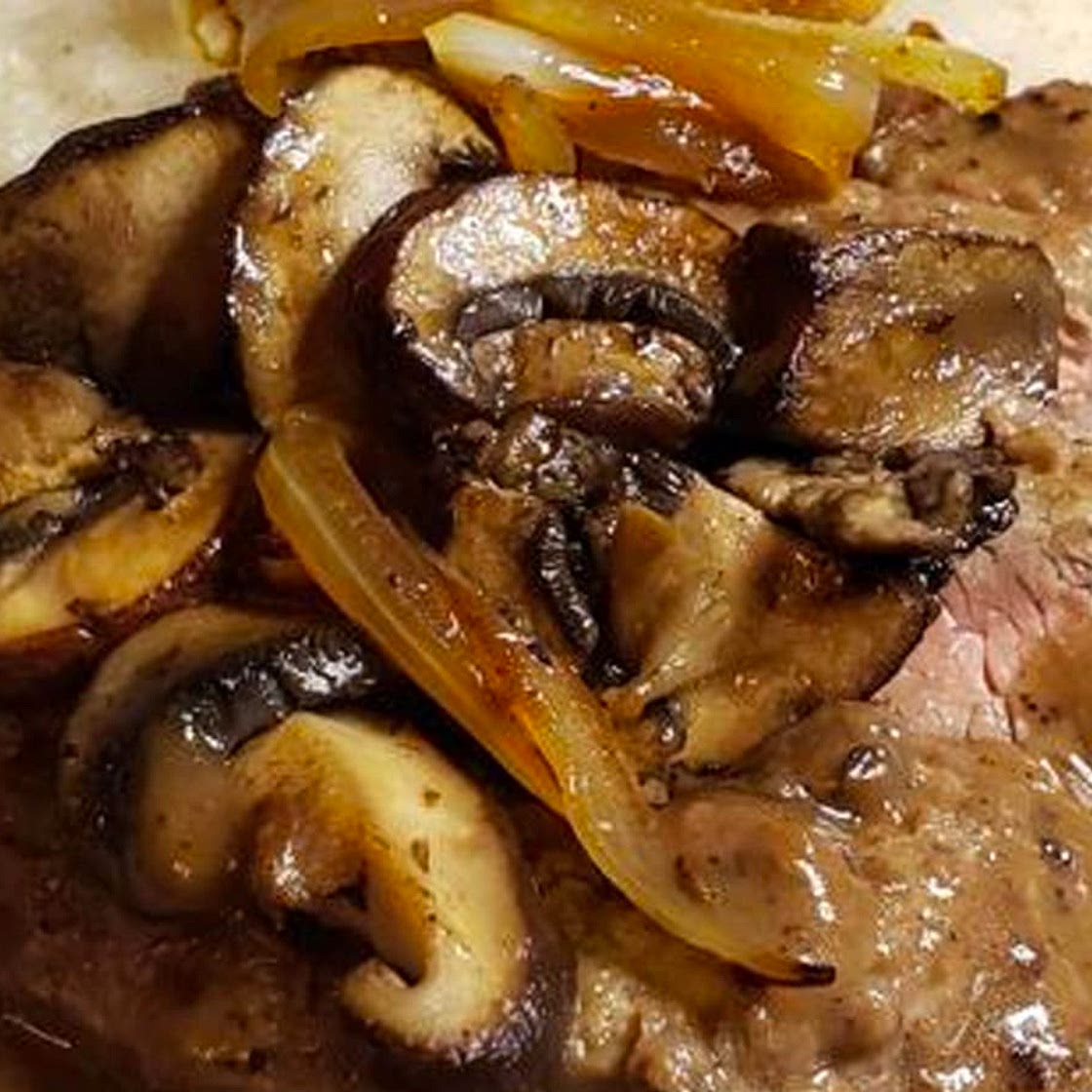 Smothered Steak and Mushrooms Over Creamy Grits Recipe