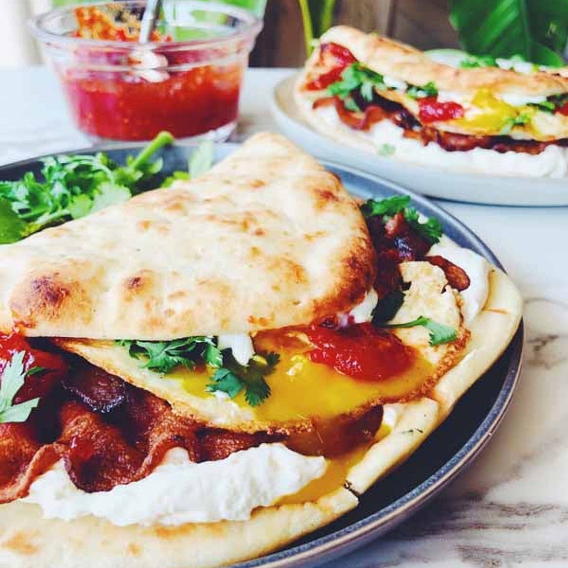 Dishoom's Naan Breakfast Sandwich with Bacon, Cream Cheese, Chili-Tomato Jam & Cilantro