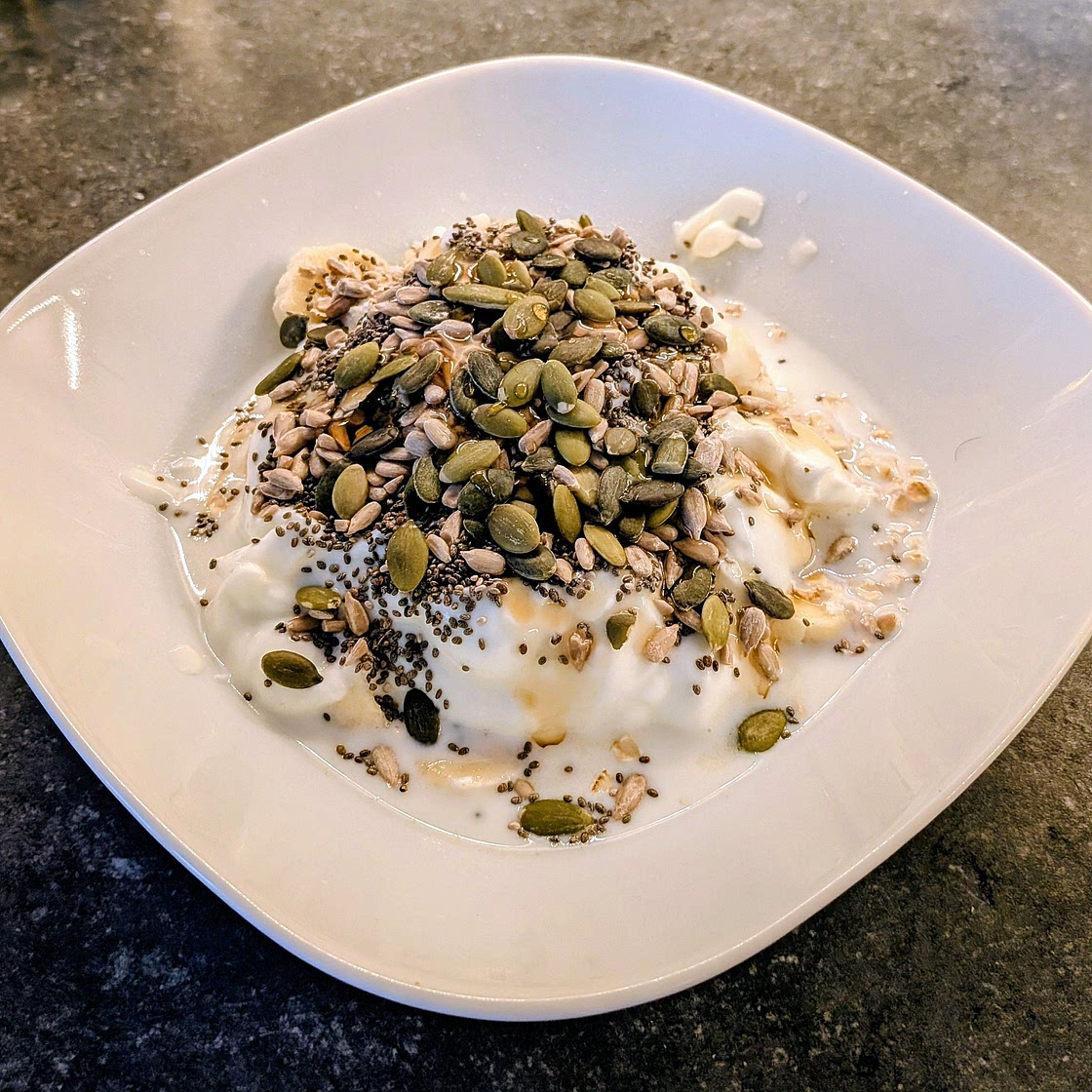 Fruit, oats yogurt & seeds breakfast bowl