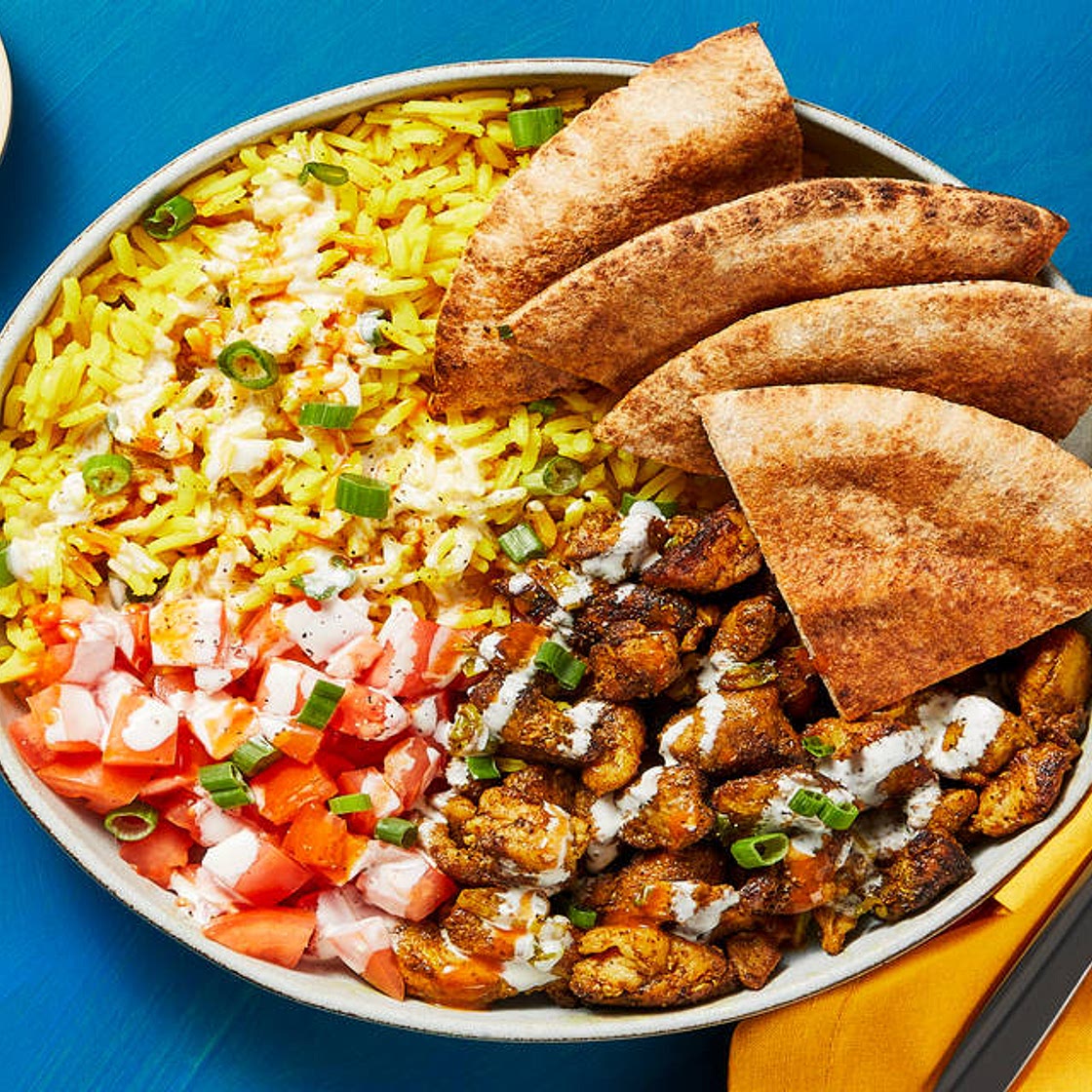 Street Cart-Style Chicken Bowls with Yellow Rice, White Sauce & Pita Wedges