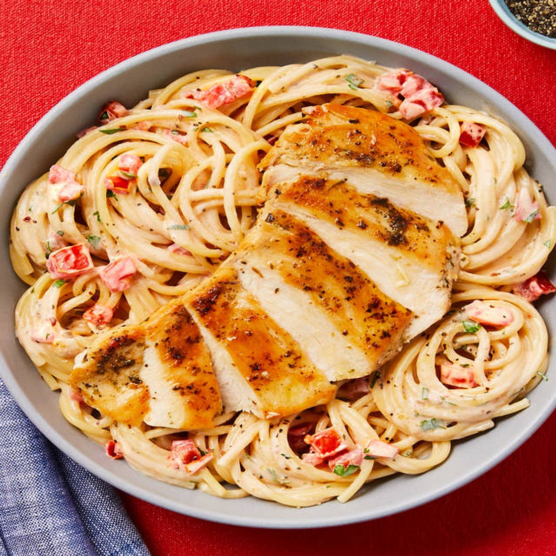 Creamy Aglio E Olio Chicken Pasta with Chili Flakes, Roma Tomato & Chopped Parsley