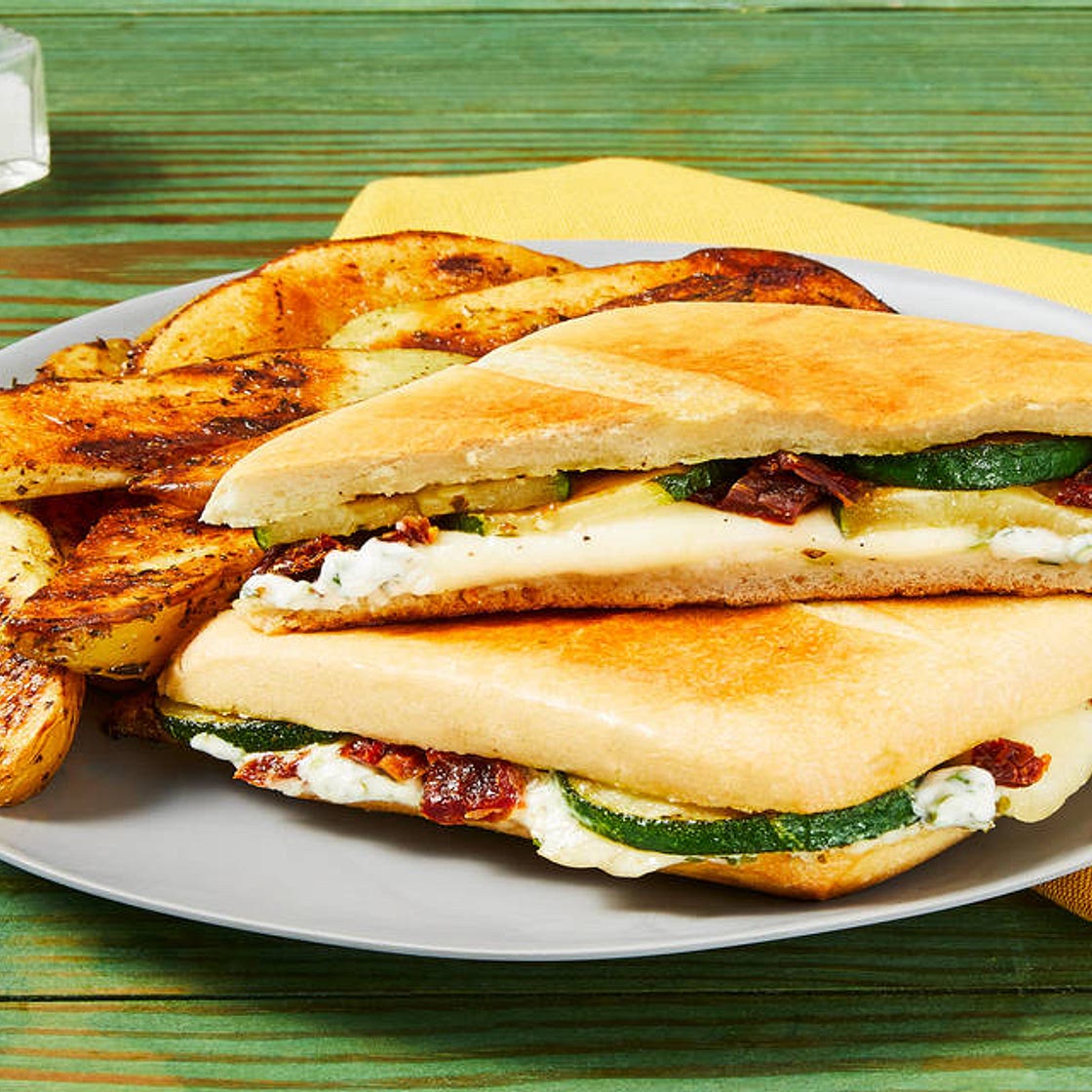 Zucchini, Mozz & Sun-Dried Tomato Panini with Herb Sauce & Italian-Seasoned Potato Wedges