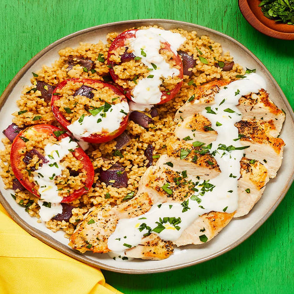 Za’atar-Spiced Chicken with Bulgur-Stuffed Roasted Tomatoes & Lemon Garlic Yogurt Sauce