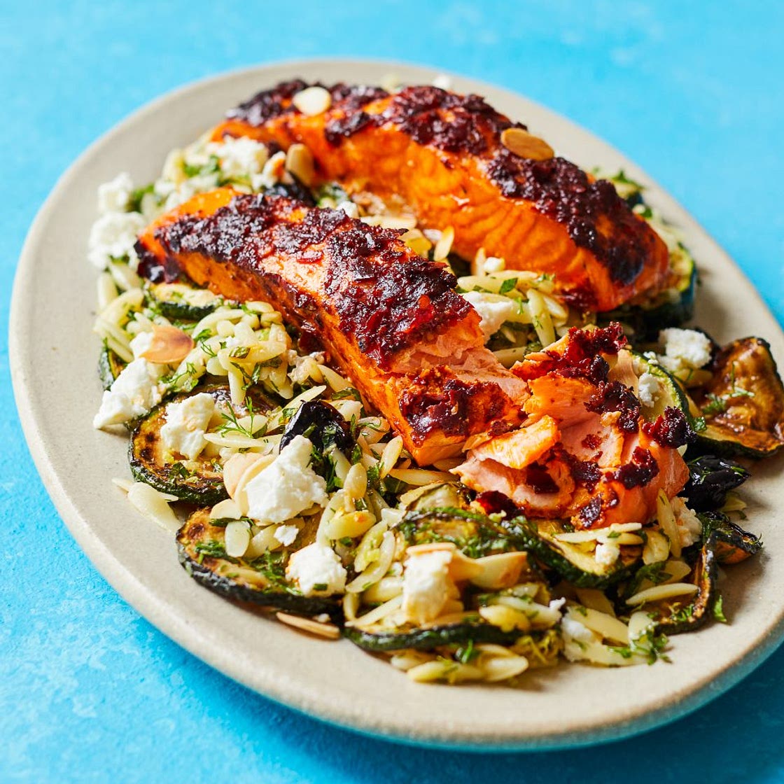 Harissa salmon with orzo courgette salad