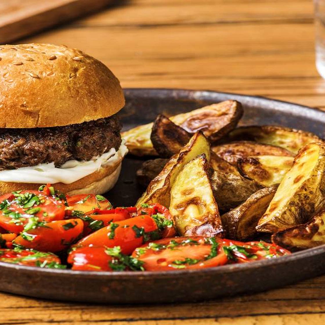 Herby Beef Burgers with Potato Wedges and Tomato Salad