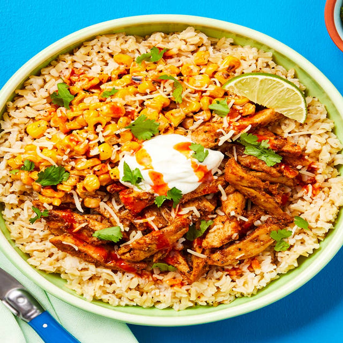 Taqueria Chicken Bowls with Brown Rice, Corn Esquites, Sour Cream, Hot Sauce & Cilantro