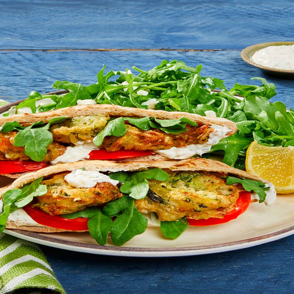 Zucchini & Feta Fritter Pita Pockets with Feta, Creamy Dill Sauce & Arugula Salad