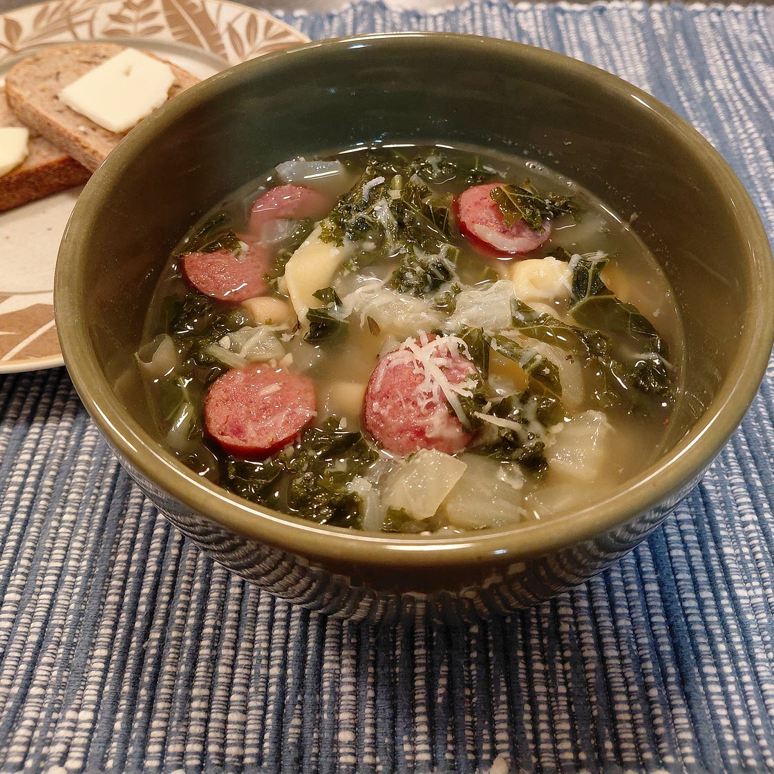 Cheese tortellini soup with cannellini, kielbasa, and kale.