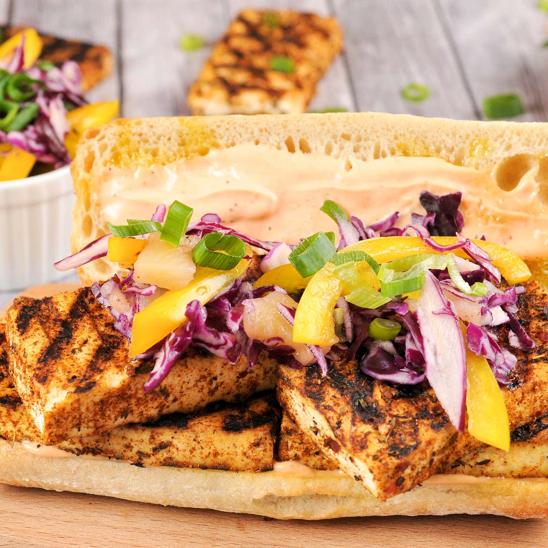 Jamaican Jerk-Seasoned Tofu Sandwich with pineapple-pepper slaw and Sriracha aioli