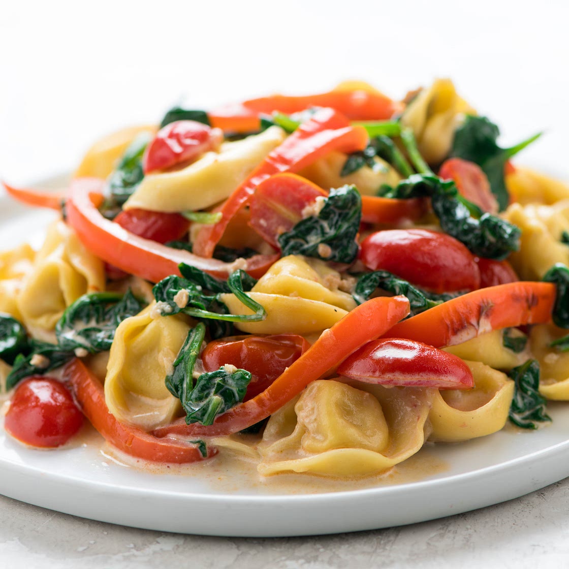 Creamy Tomato Parmesan Tortellini with spinach and red bell pepper