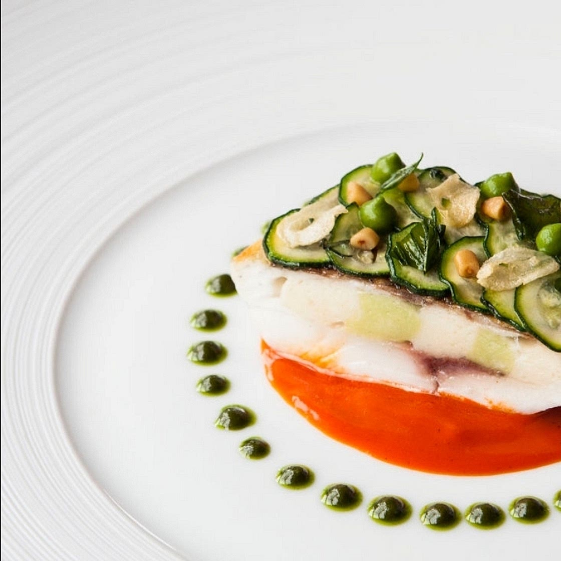 Chartreuse of Sea Bass with Scallop Mousse and "Liquid Gold" Saffron Consommé.