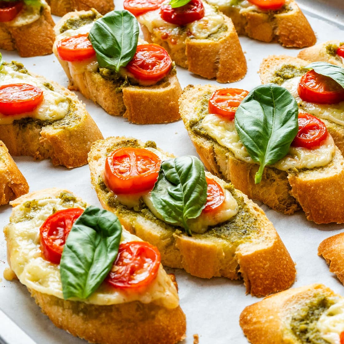 Pesto Crostini with Cheese and Tomatoes