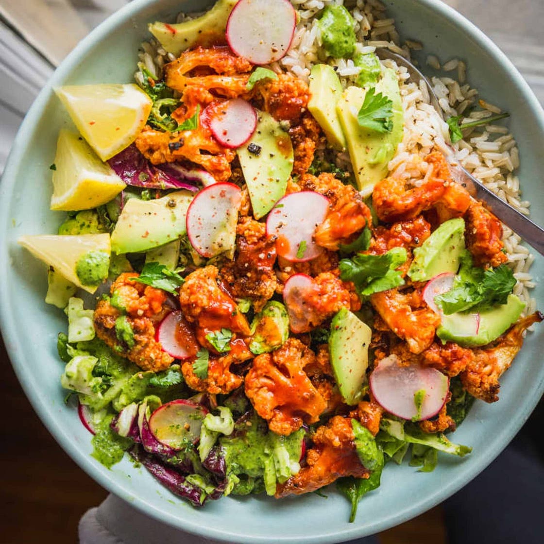 Recipe: Spicy Buffalo Cauliflower Bowls with Avocado and Green Tahini