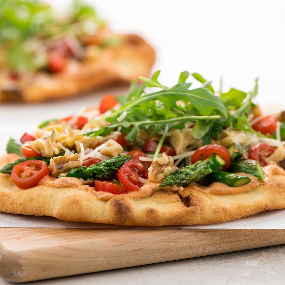 Asparagus & Tomato Flatbread with Roasted Red Pepper Crema with Asiago cheese and arugula