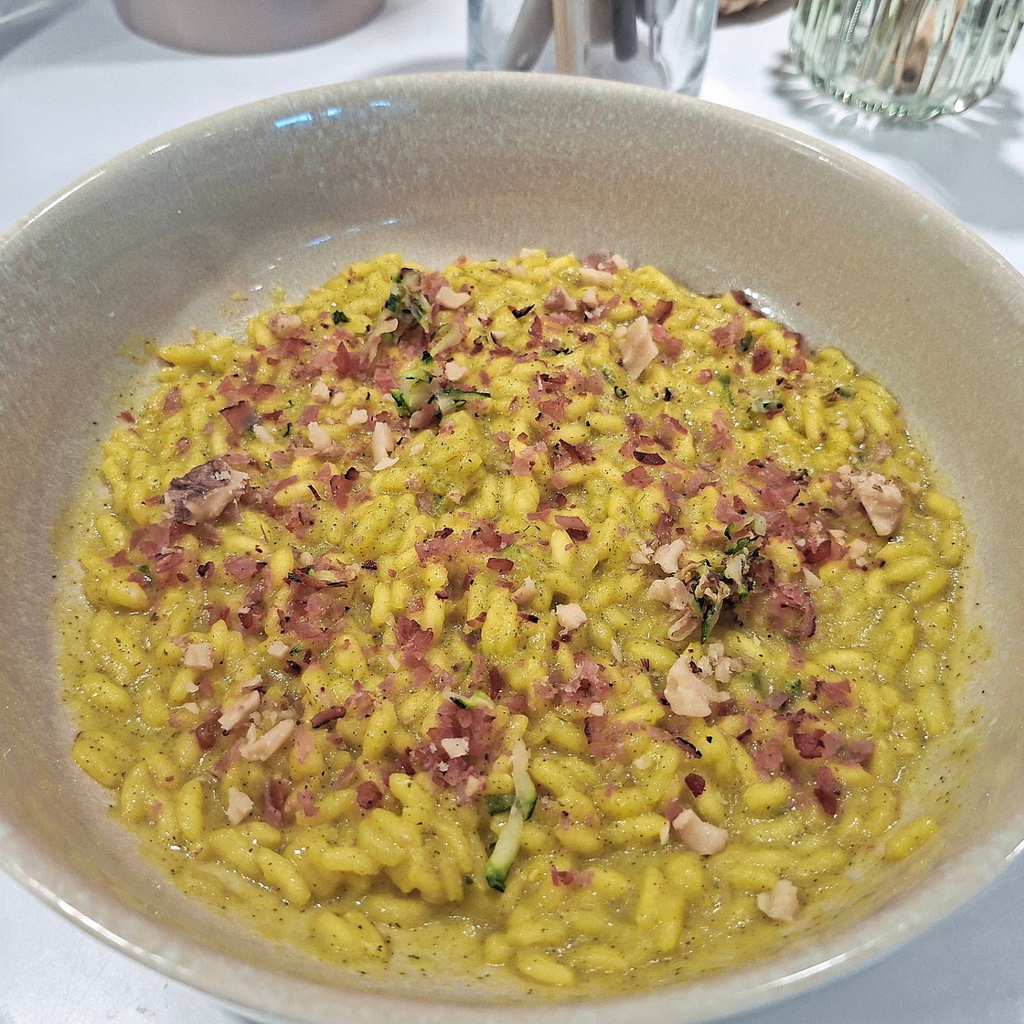 Risotto - Zucchini and saffron cream with crumbled speck and walnuts