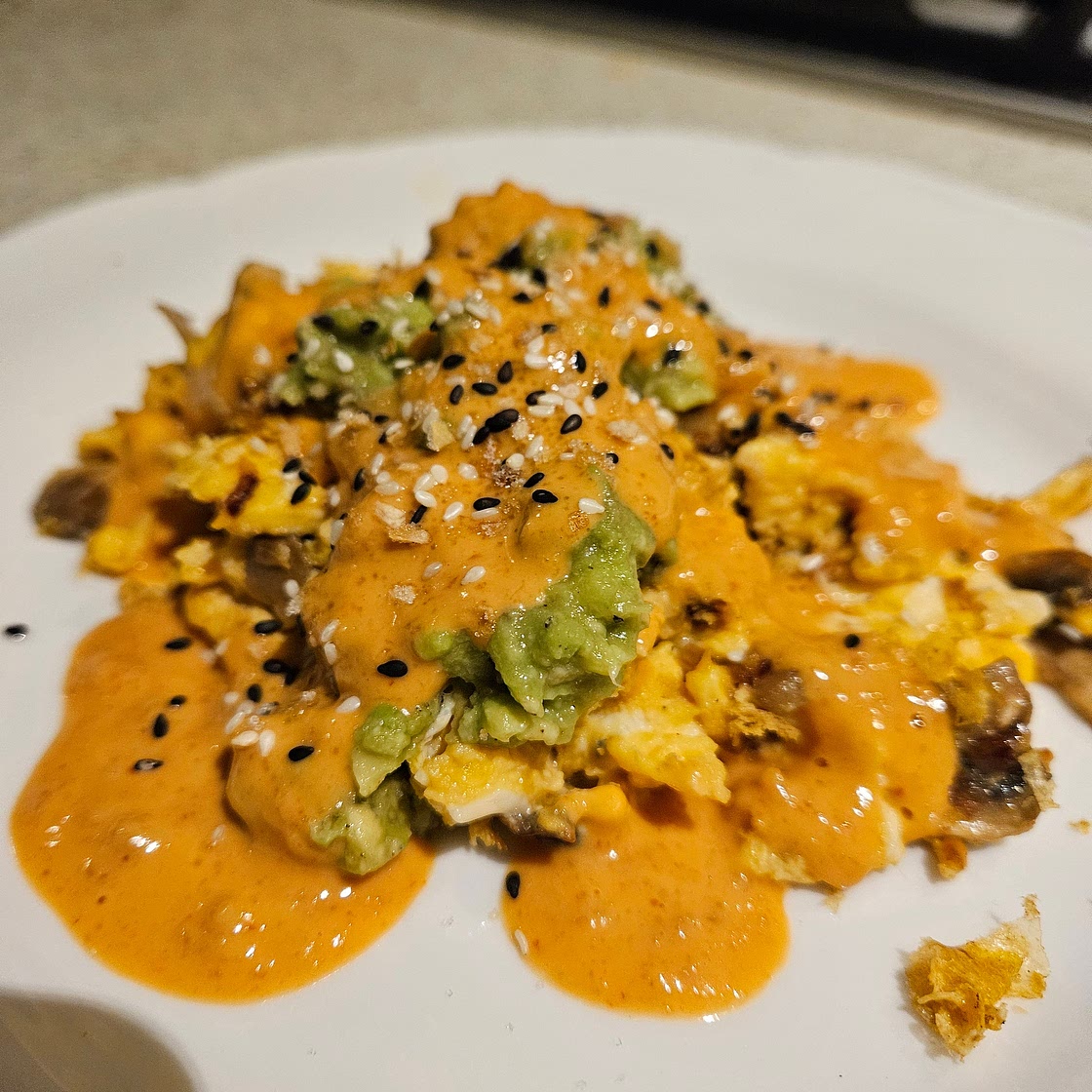 Garlic Mushroom Scramble with Smashed Avo and Spicy Peanut Drizzle
