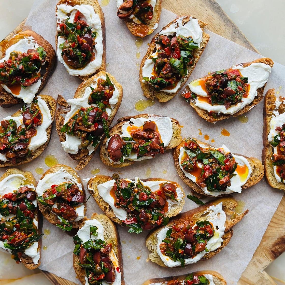 Puttanesca crostinis with whipped ricotta