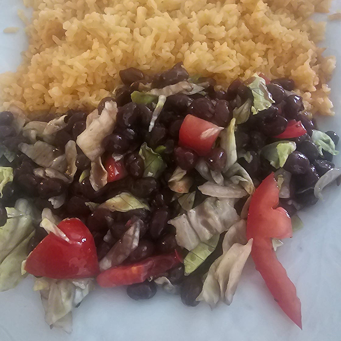 Rice and black beans, salad.
