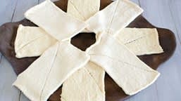 Separate dough from second can into 4 more rectangles. Arrange rectangles into an “X” that overlaps the cross, leaving an open circle in the center.