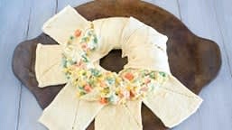 Pull overhanging dough from outer edge towards center and over filling. Tuck and pinch dough under middle.