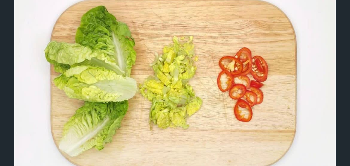Meanwhile, wash then remove the outer leaves from the gem lettuce and set aside, then shred the inner core. Slice the red chilli[es] into rounds. Peel then finely chop garlic and ginger.