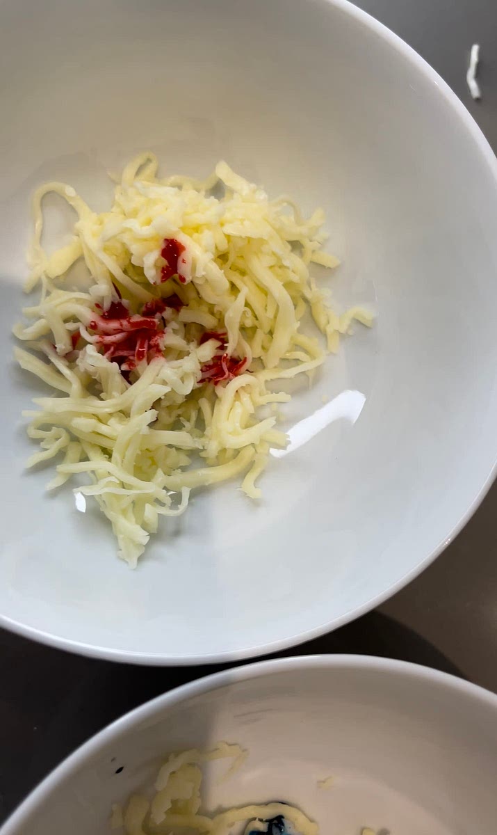 Add food coloring to shredded cheese