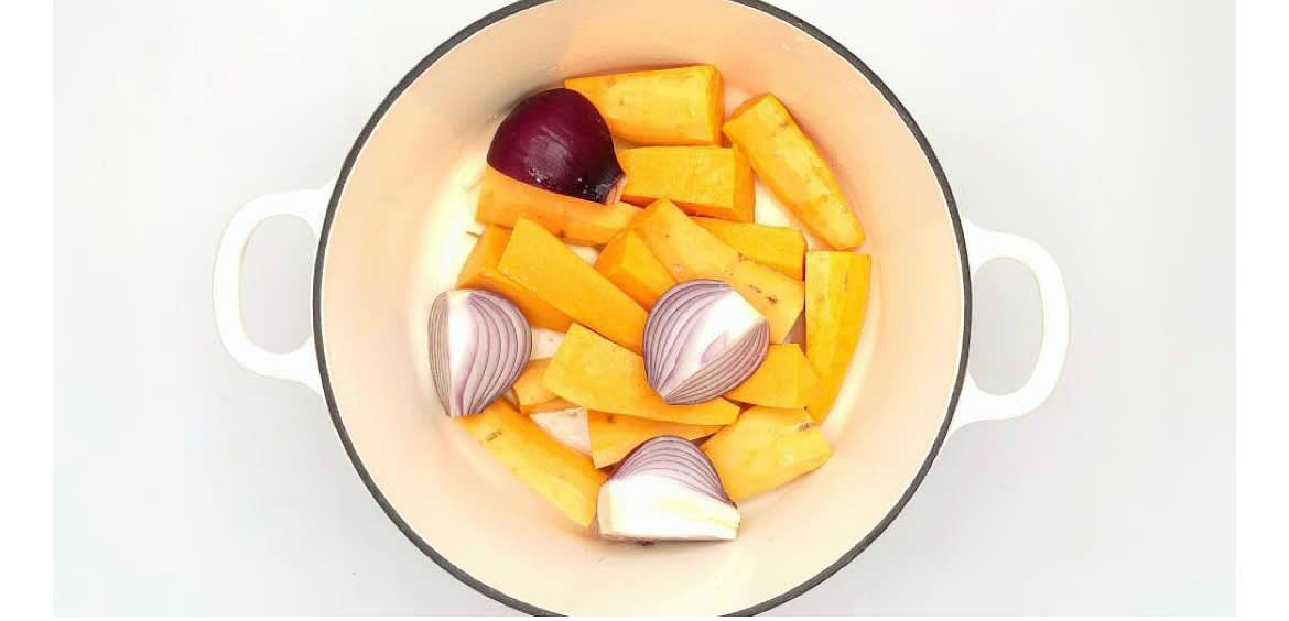 Add the chopped sweet potato to the dish with the onion wedges and a pinch of salt. Drain and rinse the black beans and sweetcorn. Crush the garlic open by squashing it with the side of a knife and discard the skins.