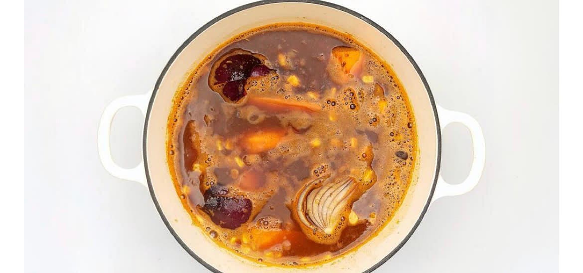 Add the black beans and sweetcorn to the dish with the tomato paste, chipotle paste (can't handle the heat? Go easy!) and boiled water. Add the vegetable stock mix and soy sauce and bring to the boil over a high heat. Cover with the lid and put the dish in the oven for 25 min - this is your oven-baked Mexican sweet potato & corn broth. Use this time to clear up, set the table, have a cup of tea or simply chill!