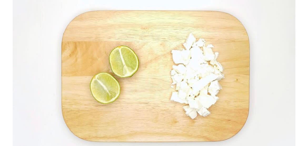 Roll the lime[s] with your hand on a hard surface (to release more juice) and cut in half. Crumble the feta into rough bite-sized pieces.