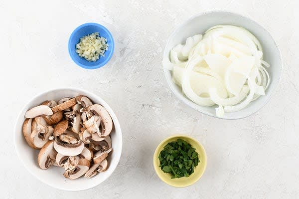 Prepare the Ingredients:
Cut mushrooms into 1/4" slices. Stem and coarsely chop parsley. Halve and peel onion. Slice halves into thin strips. Mince garlic. Pat shrimp dry.