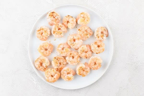 Cook the Shrimp
Heat 1 tsp. olive oil in a large non-stick pan over medium-high heat. Add shrimp and a pinch of salt and pepper to hot pan. Cook until lightly browned and shrimp reach a minimum internal temperature of 145 degrees, 2-3 minutes per side. Transfer shrimp to a plate. Reserve pan; no need to wipe clean.