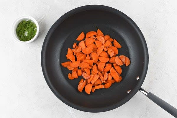 Cook the Carrots
Place a large non-stick pan over medium-high heat. Add 2 tsp. olive oil, garlic salt, and carrots to hot pan. Stir often until lightly browned, 2-3 minutes. Add 1/4 cup water and cover. Cook until water is mostly evaporated and carrot is tender, 4-5 minutes. Remove from burner. While carrots cook, stem dill.