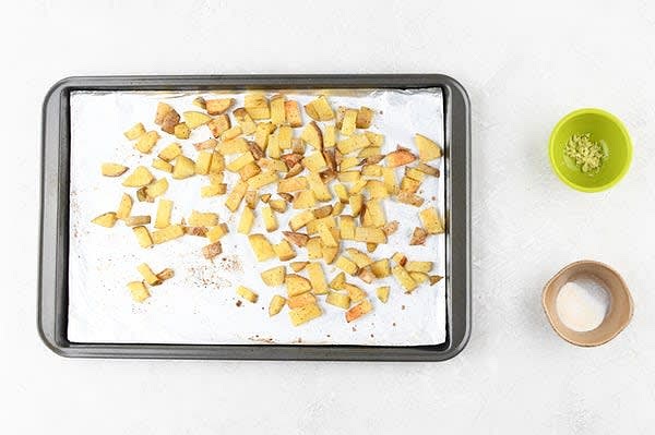 Roast the Potatoes
Cut potatoes into 1/2" dice. Place potatoes on prepared baking sheet and toss with 2 tsp. olive oil, half the garlic salt (reserve remaining for steak), and a pinch of pepper. Massage oil, garlic salt, and pepper into potatoes. Spread into a single layer. Roast in hot oven, 20 minutes. Carefully remove from oven and gently stir in half the garlic (reserve remaining for sauce; prepared in a later step.) Spread into a single layer and roast again until potatoes are browned and tender, 4-6 minutes. While potatoes roast, prepare ingredients.