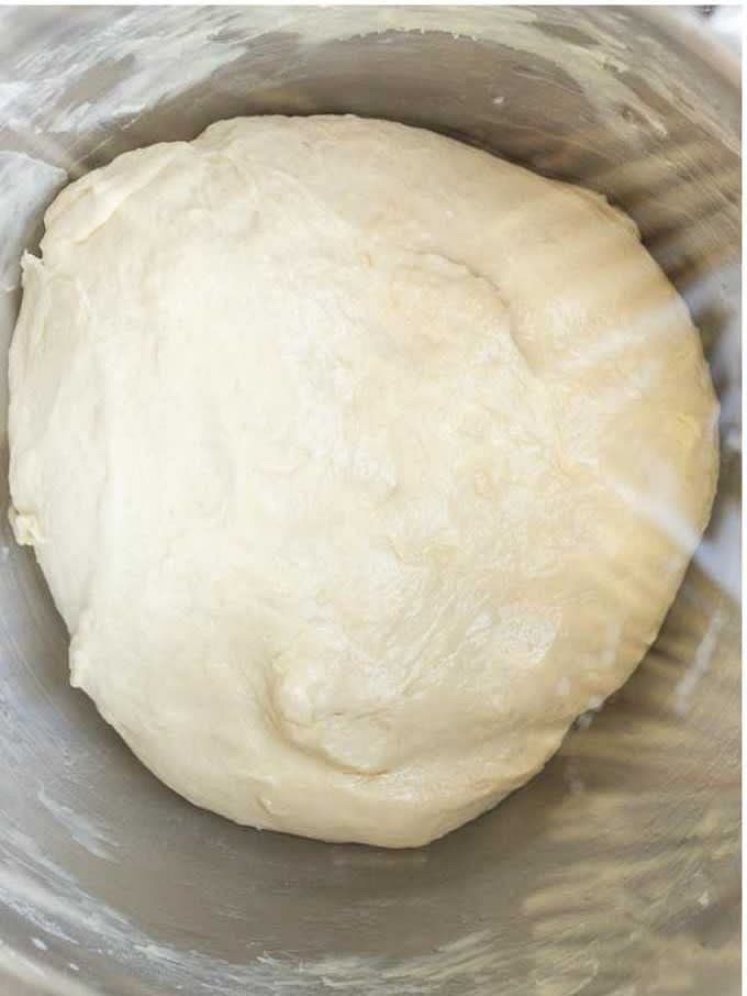 Transfer the dough to a lightly greased bowl and make sure that it is completely coated. Cover with plastic wrap and let rise in a warm and draft-free place for about 45 minutes or until doubled in size.