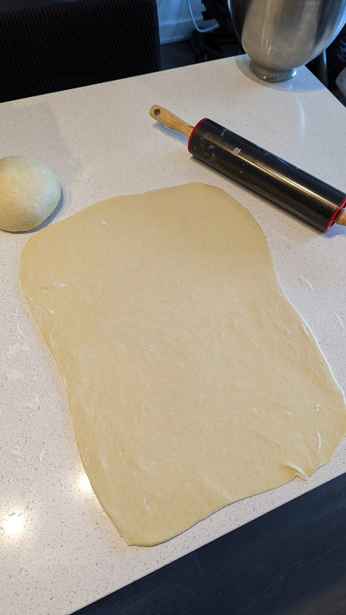 Divide the dough in half and stretch with a rolling pin each half in a rectangle shape, around 40h x 30w cm