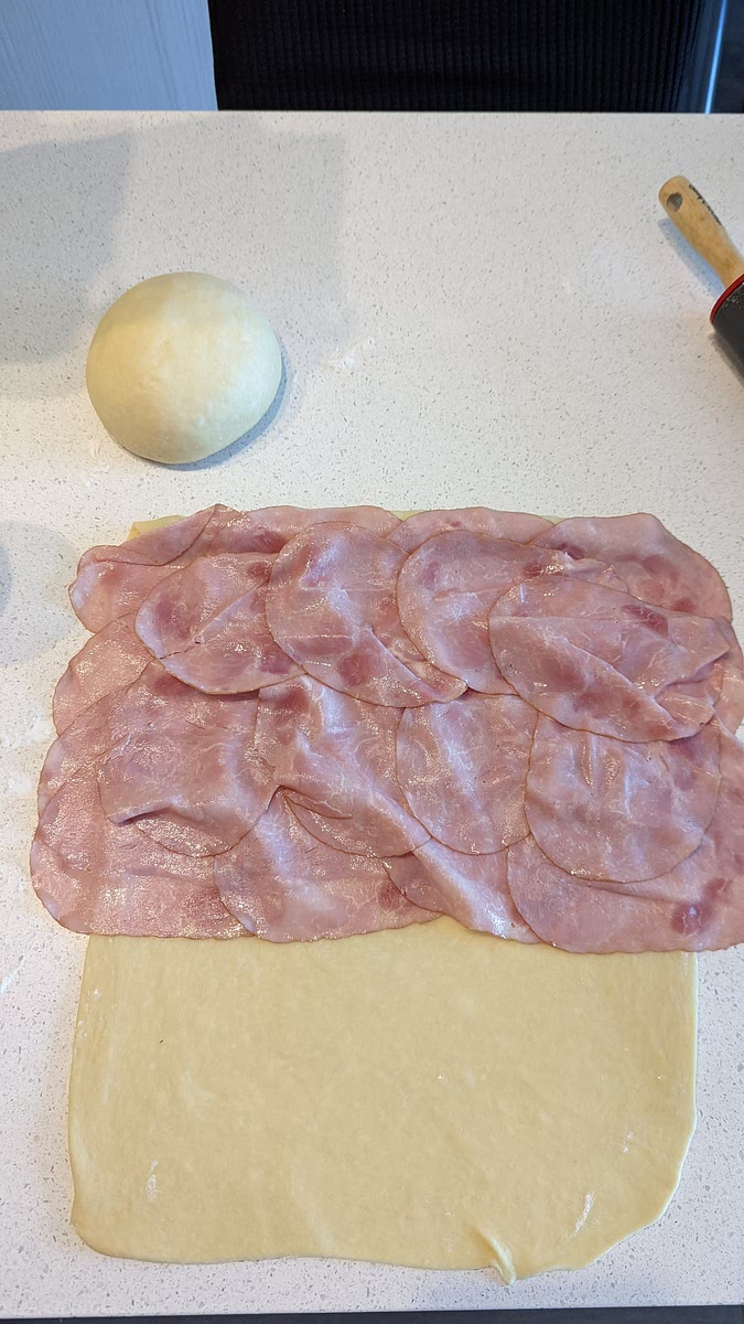 Add ham to no more than 60% of the dough from the top