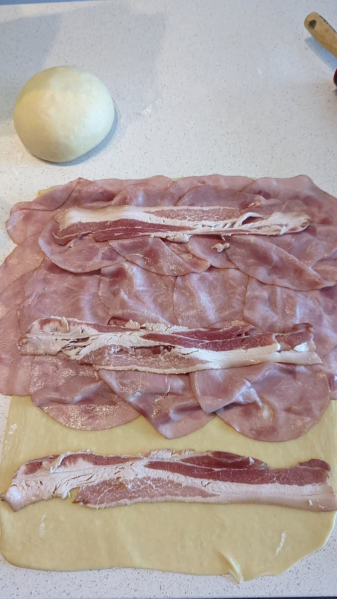 Add 3 bacon strips horizontally, spread evenly