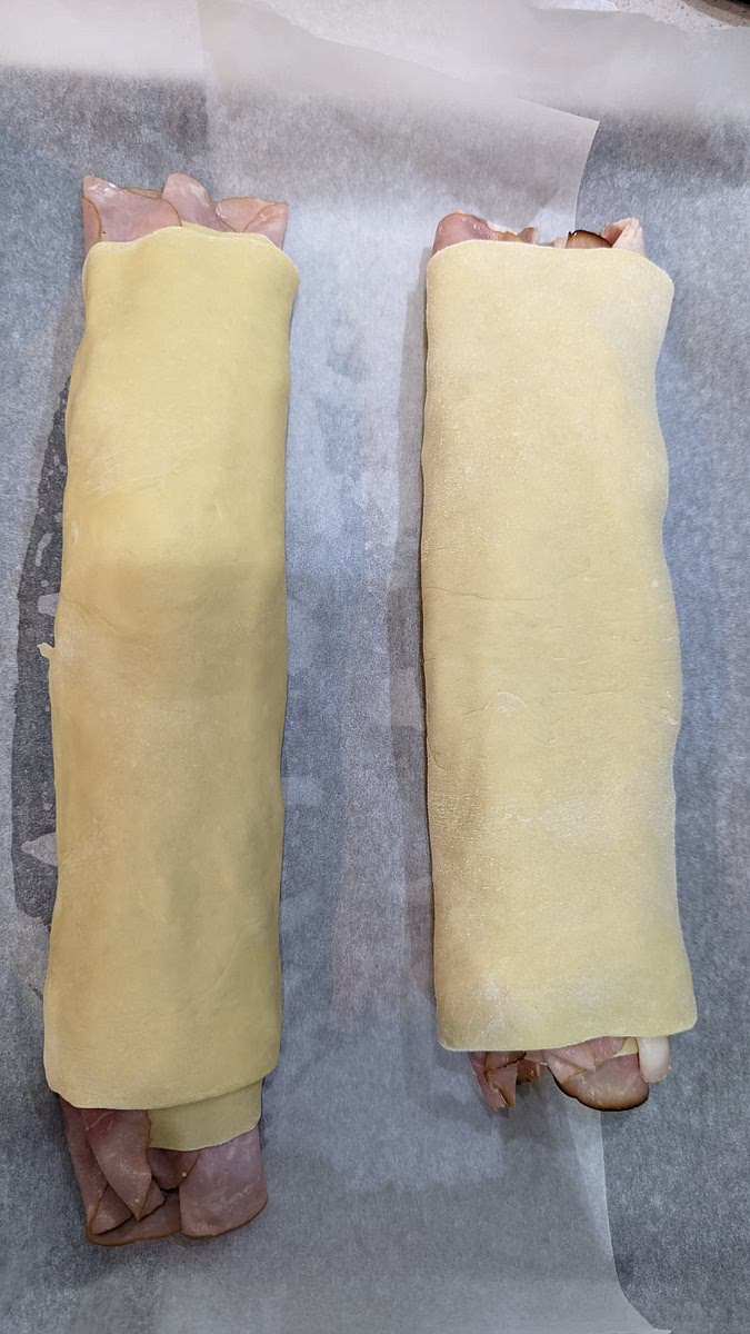 Roll in the dough. Add parchment paper to a baking sheet and let the dough rest for 20 minutes while the oven is pre heated